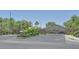 Community gated entrance with manicured landscaping and trees at 2410 Sunburst View St, Henderson, NV 89052