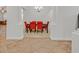 Dining area with red upholstered chairs and stylish overhead lighting, adjacent to entry at 2410 Sunburst View St, Henderson, NV 89052