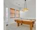 Well-lit game room with a pool table under a decorative lamp, offering a recreational space at 2410 Sunburst View St, Henderson, NV 89052