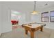 Game room transitions to a dining area with elegant furnishings and adjacent to entry at 2410 Sunburst View St, Henderson, NV 89052