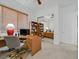 Spacious home office with a large desk, shelving, and mirrored closet doors at 2410 Sunburst View St, Henderson, NV 89052