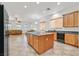 Modern kitchen featuring a granite island and updated stainless steel appliances at 2410 Sunburst View St, Henderson, NV 89052
