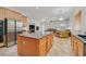 Open concept kitchen with a large island, stainless appliances, and access to the living room at 2410 Sunburst View St, Henderson, NV 89052
