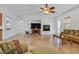 A spacious living room featuring tile floors, fireplace, and a ceiling fan at 2410 Sunburst View St, Henderson, NV 89052