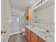 This bathroom features a glass door shower, double sinks and wood cabinets at 2633 S Durango Dr # 204, Las Vegas, NV 89117