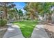 Well-maintained common area with mature trees, green grass, and sidewalks at 2633 S Durango Dr # 204, Las Vegas, NV 89117