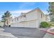 Low angle shot showing exterior of condo building with multiple garages, balconies, and red clay roof at 2633 S Durango Dr # 204, Las Vegas, NV 89117