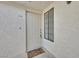 Close-up of the front door and entrance to unit 204 with a small window and 'Welcome' mat at 2633 S Durango Dr # 204, Las Vegas, NV 89117