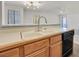 Bright kitchen features wood cabinets, a stainless steel faucet, and sleek appliances at 2633 S Durango Dr # 204, Las Vegas, NV 89117