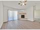 Living room area featuring new floors, sliding doors, and tiled fireplace at 2633 S Durango Dr # 204, Las Vegas, NV 89117