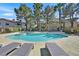 Community swimming pool with lounge chairs and mature landscaping at 2633 S Durango Dr # 204, Las Vegas, NV 89117
