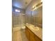 Bathroom with tile floors, light wood cabinetry, granite counters, and a shower-tub combination at 2694 Rimpacific Cir, Las Vegas, NV 89146