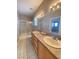 Bathroom featuring double sinks, granite counters, light wood cabinetry, tile floors, and a shower-tub combination at 2694 Rimpacific Cir, Las Vegas, NV 89146