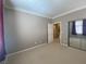 Neutral bedroom with beige carpet, white trim, neutral paint, a closet, and a view to other rooms at 2694 Rimpacific Cir, Las Vegas, NV 89146