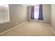 Bedroom featuring natural light from two windows, neutral paint, carpet, and curtains at 2694 Rimpacific Cir, Las Vegas, NV 89146
