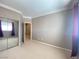 Bedroom with beige carpet, white trim, neutral paint, a closet, and a view to other rooms at 2694 Rimpacific Cir, Las Vegas, NV 89146