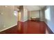 Bright living room featuring vaulted ceilings, fresh paint, wood-look flooring, and hallway access at 2694 Rimpacific Cir, Las Vegas, NV 89146
