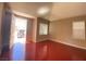 Bright living room featuring vaulted ceilings, fresh paint, wood-look flooring, and secured entryway at 2694 Rimpacific Cir, Las Vegas, NV 89146