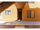 Exterior shot of the apartment entrance featuring a sidewalk, desert landscaping and yellow accents at 2700 N Rainbow Blvd # 1080, Las Vegas, NV 89108
