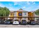 Apartment complex featuring covered parking, yellow exterior accents, and well-maintained landscaping at 2700 N Rainbow Blvd # 1080, Las Vegas, NV 89108