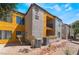 Apartment complex with balconies, desert landscaping and yellow exterior accents on a sunny day at 2700 N Rainbow Blvd # 1080, Las Vegas, NV 89108