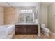 Bathroom featuring a soaking tub, granite counters, and tile flooring at 2700 N Rainbow Blvd # 1080, Las Vegas, NV 89108