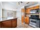 Charming kitchen features tile floors, stainless steel stove and microwave and wood cabinets at 2700 N Rainbow Blvd # 1080, Las Vegas, NV 89108