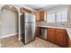 Kitchen features tile floors, stainless steel refrigerator, wine rack, and ample counterspace at 2700 N Rainbow Blvd # 1080, Las Vegas, NV 89108