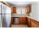 Well-lit kitchen featuring stainless steel appliances, granite countertops, and stylish backsplash at 2700 N Rainbow Blvd # 1080, Las Vegas, NV 89108
