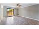Bright, spacious living room with tile flooring, ceiling fan, and sliding glass door to a patio at 2700 N Rainbow Blvd # 1080, Las Vegas, NV 89108