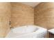 Bathroom featuring a large soaking tub with tan tile surround at 2700 N Rainbow Blvd # 1080, Las Vegas, NV 89108