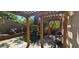 Backyard featuring a pergola, artificial turf, patio, swing, grill, and lush plants at 3131 Binaggio Ct, Las Vegas, NV 89141