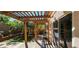 Back patio featuring a pergola, artificial turf, patio, swing, grill and a glass sliding door at 3131 Binaggio Ct, Las Vegas, NV 89141