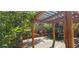 Pergola covered patio with swing, potted plants and brick planters at 3131 Binaggio Ct, Las Vegas, NV 89141