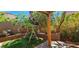 Cozy backyard retreat featuring a charming swing, lush greenery, and well-maintained artificial turf at 3131 Binaggio Ct, Las Vegas, NV 89141