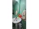 Charming bathroom with a modern pedestal sink and decorative towel adding flair at 3131 Binaggio Ct, Las Vegas, NV 89141