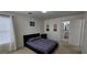 Nicely staged bedroom showing black bed and bathroom access at 3131 Binaggio Ct, Las Vegas, NV 89141