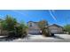Inviting two-story home with a two-car garage, desert landscaping, and a bright blue sky at 3131 Binaggio Ct, Las Vegas, NV 89141