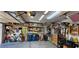 Garage interior featuring storage shelves, a bicycle, blue trash bins, and various equipment, optimizing space and utility at 3131 Binaggio Ct, Las Vegas, NV 89141