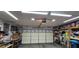 Spacious garage interior with storage shelves, tools, a bicycle, and ample space for vehicles and projects at 3131 Binaggio Ct, Las Vegas, NV 89141