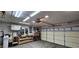 A large garage features a work bench, storage and a garage door at 3131 Binaggio Ct, Las Vegas, NV 89141