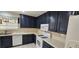 A kitchen featuring dark wood cabinets, white countertops, and modern appliances at 3131 Binaggio Ct, Las Vegas, NV 89141