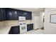 A kitchen with white appliances, countertops and dark wood cabinets at 3131 Binaggio Ct, Las Vegas, NV 89141