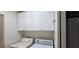 A laundry room has a washer, dryer, and cabinets above at 3131 Binaggio Ct, Las Vegas, NV 89141