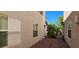 Narrow side yard with desert landscaping between stucco walls and small window at 3131 Binaggio Ct, Las Vegas, NV 89141