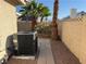 Landscaped backyard featuring artificial grass, bushes, and desert landscaping at 3136 Jane Austin Ave, North Las Vegas, NV 89031