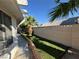 Landscaped backyard featuring artificial grass and desert landscaping at 3136 Jane Austin Ave, North Las Vegas, NV 89031