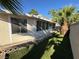 Backyard with artificial grass, patio, and block wall at 3136 Jane Austin Ave, North Las Vegas, NV 89031