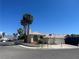 Charming stucco home features a tile roof, two-car garage, palm trees, and corner lot appeal at 3136 Jane Austin Ave, North Las Vegas, NV 89031