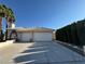 Well-maintained home featuring desert landscaping, palm trees, and a two-car garage at 3136 Jane Austin Ave, North Las Vegas, NV 89031